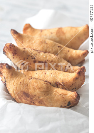 Cherry empanadas on the white baking paper 40777132