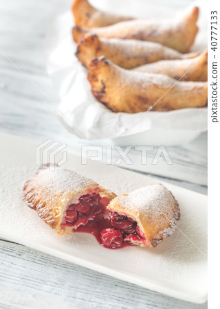 Cherry empanadas on the white plate 40777133