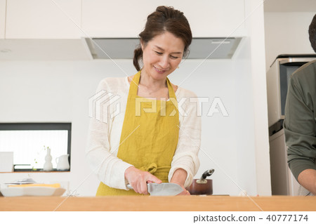 A Japanese middle-class couple standing in the kitchen A Japanese middle-class couple standing in the kitchen 40777174