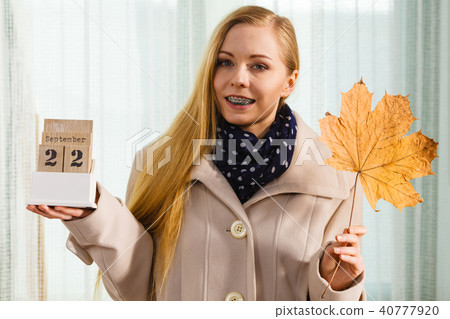 Woman holding calendar with first autumn day 40777920