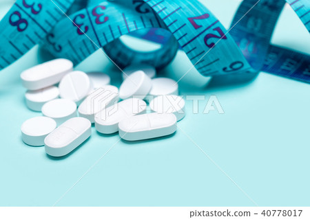 Pills spilling out of pill bottle 40778017