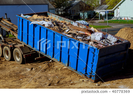 Truck loading a full skip recycling garbage  40778369