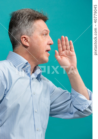 Isolated on pink casual man shouting at studio 40779045