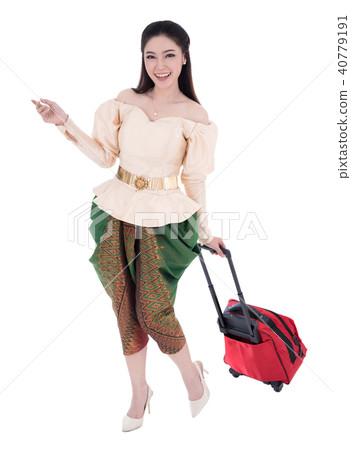 woman in Thai traditional dress walking & dragging suitcases iso 40779191