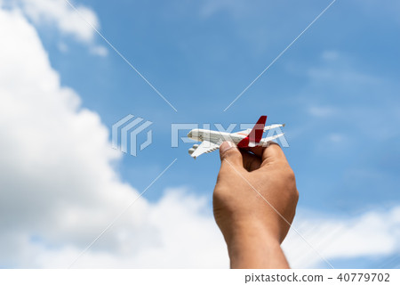 Hand of man holding a toy plane Hand of man holding a toy plane 40779702
