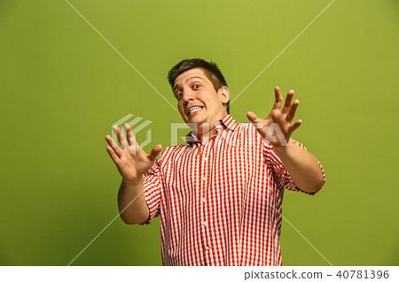 Let me think. Doubtful pensive man with thoughtful expression making choice against green background Let me think. Doubtful pensive man with thoughtful expression making choice against green background 40781396