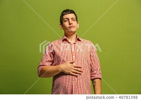 The happy businessman standing and smiling against green background. The happy businessman standing and smiling against green background. 40781398