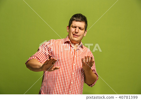 Let me think. Doubtful pensive man with thoughtful expression making choice against green background Let me think. Doubtful pensive man with thoughtful expression making choice against green background 40781399