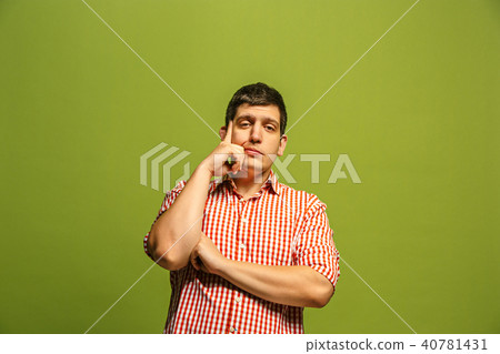 Beautiful bored man isolated on green background 40781431