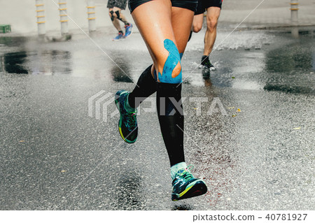 legs runner woman with kinesio tape 40781927