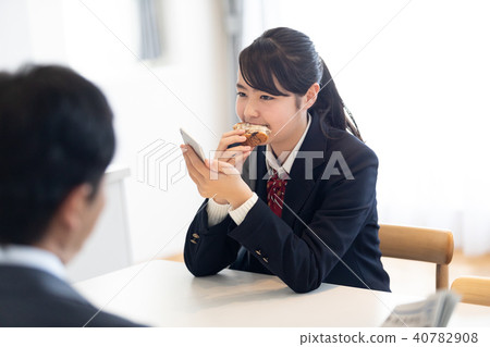 School girl who hurries to eat breakfast School girl who hurries to eat breakfast 40782908