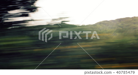Defocused trees viewed through a car windscreen. Defocused trees viewed through a car windscreen. 40785479