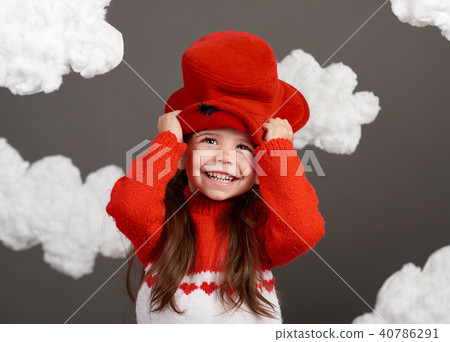 girl playing with clouds, dressed in red sweater girl playing with clouds, dressed in red sweater 40786291