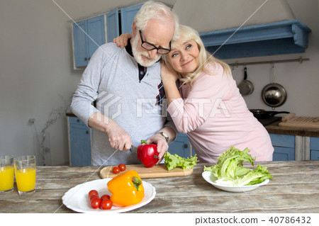 Senior couple cooking together. Senior couple cooking together. 40786432