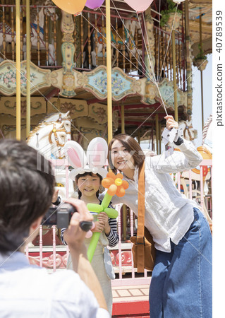 爸爸拍攝媽媽和女兒在遊樂園裡 40789539