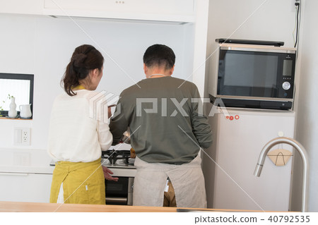 Japanese middle senior couple standing in the kitchen Japanese middle senior couple standing in the kitchen 40792535