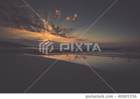 Sunset on beach with a wooden breakwater in Leba, Sunset on beach with a wooden breakwater in Leba, 40805356