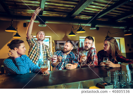 Sport, people, leisure, friendship and entertainment concept - happy football fans or male friends 40805536