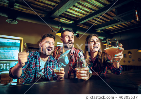 Sport, people, leisure, friendship and entertainment concept - happy football fans or male friends 40805537