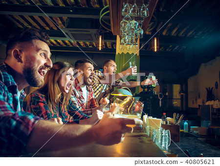 Sport, people, leisure, friendship and entertainment concept - happy football fans or male friends 40805621
