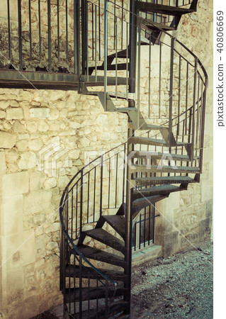 Very old outdoor spiral staircase 40806669