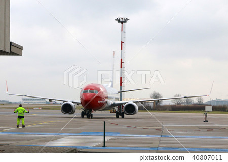 BERLIN, GERMANY - JAN 17th, 2015: Norwegian Boeing 737 airplane arriving at the gate in Berlin BERLIN, GERMANY - JAN 17th, 2015: Norwegian Boeing 737 airplane arriving at the gate in Berlin 40807011