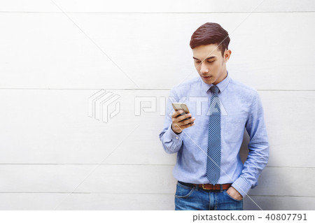 Portrait of Young Businessman using Smartphone Portrait of Young Businessman using Smartphone 40807791