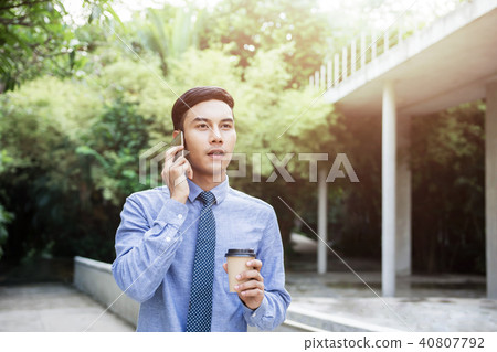 Young Motivation Businessman Talk via Smartphone Young Motivation Businessman Talk via Smartphone 40807792