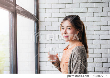 Lovely Asian Woman Relaxing in Cozy House Lovely Asian Woman Relaxing in Cozy House 40807796