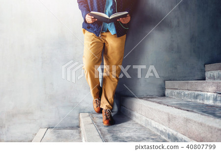 Lower Part of Person Standing and Reading Book Lower Part of Person Standing and Reading Book 40807799