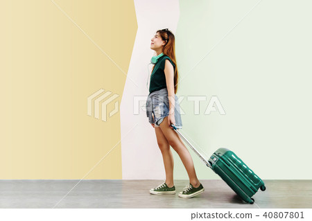 Happy Young Traveler Woman Walking with Suitcase Happy Young Traveler Woman Walking with Suitcase 40807801