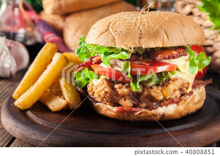 Delicious burger with chicken, bacon and cheese Delicious burger with chicken, bacon and cheese 40808851