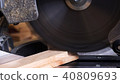 Carpenter tools on wooden table with sawdust. Circular Saw. Cutting a wooden plank 40809693