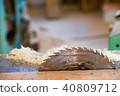 Carpenter tools on wooden table with sawdust. Circular Saw. Cutting a wooden plank 40809712