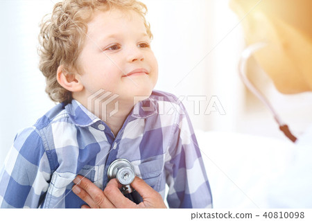 Doctor and child patient. Physician examines little boy by stethoscope. Medicine and children's Doctor and child patient. Physician examines little boy by stethoscope. Medicine and children's 40810098