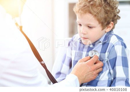 Doctor and child patient. Physician examines little boy by stethoscope. Medicine and children's 40810108