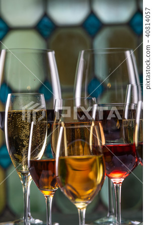 Champagne, white, rose and red wins and drinks in glasses on stained glass background Champagne, white, rose and red wins and drinks in glasses on stained glass background 40814057