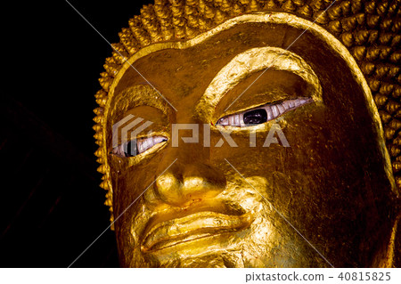 Golden buddha statue imagery in Buddhist temple  40815825