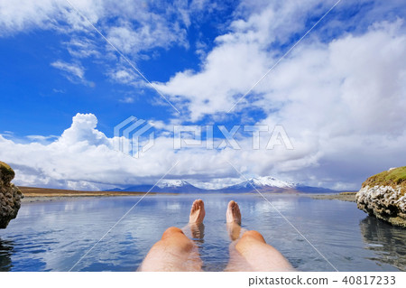 The legs of an athletic man in natural thermal hot spring Polloquere, Salar De Surire salt lake The legs of an athletic man in natural thermal hot spring Polloquere, Salar De Surire salt lake 40817233