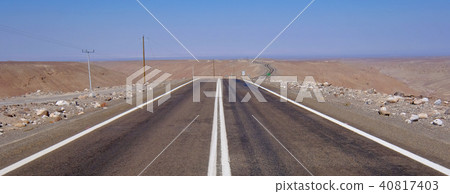 Road leading trough Atacama Desert landscape with sand, dunes and mountains, Andes near Huara, Chile 40817403