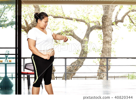 Fat Woman measuring  waistline 40820344