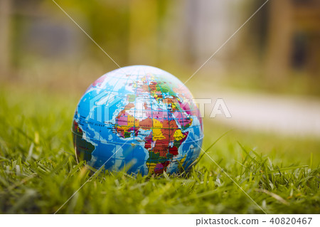 Globe lies on green grass 40820467