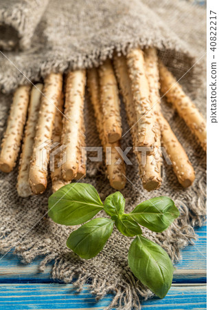 Fresh baked grissini bread on wooden board. Fresh baked grissini bread on wooden board. 40822217