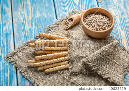 Fresh baked grissini bread on wooden board. Fresh baked grissini bread on wooden board. 40822219