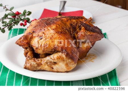 Baked chicken on white plate. 40822396