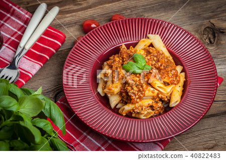 Penne a bolognese on white plate. Penne a bolognese on white plate. 40822483