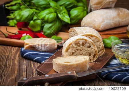 Sliced ciabatta bread on cutting board. 40822509
