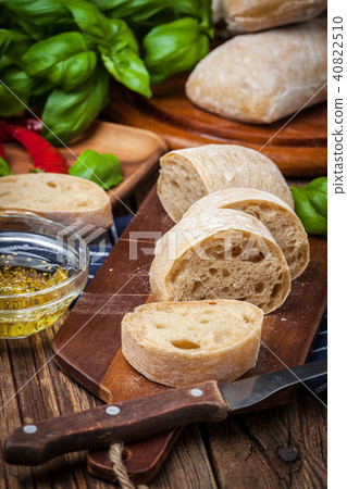 Sliced ciabatta bread on cutting board. 40822510