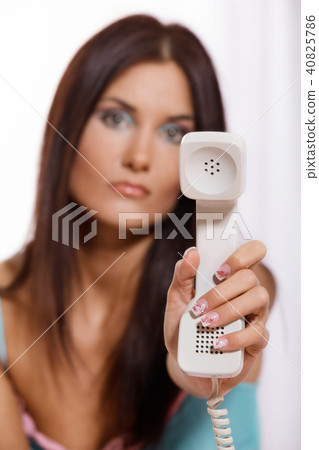 Young woman on the phone on the bed Young woman on the phone on the bed 40825786