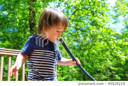 Young toddler boy playing with water 40826229